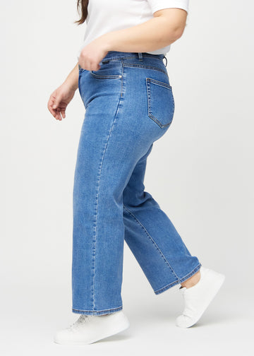 Denim loose jeans set fra siden på en plus-size model.