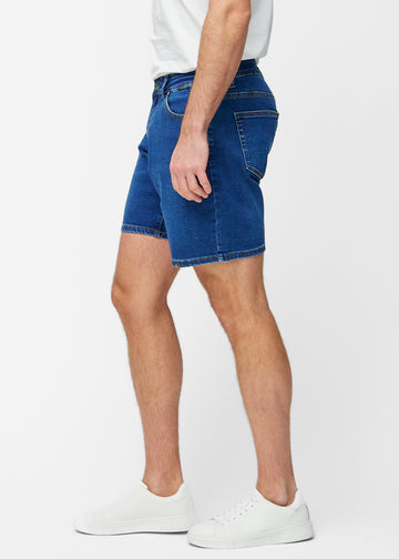 Dunkelblaue Denim-Shorts für Herren in der Farbe Oceans mit Regular-Passform von der Seite am Modell gesehen.