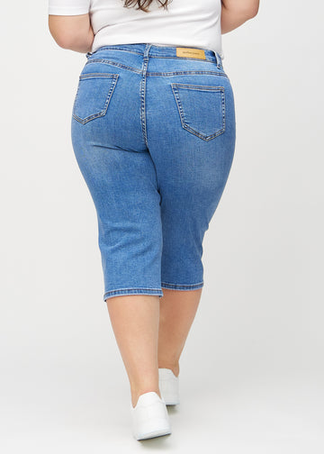 Denim-regular-Capris von hinten an einem Plus-Size-Model gezeigt, damit man das gesamte Produkt sehen kann.