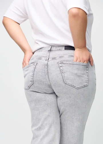 Loose-Jeans für Damen in Hellgrau, Farbe Ashes. Nahaufnahme von hinten an einem Plus-Size-Model, um die Passform und Details zu zeigen.