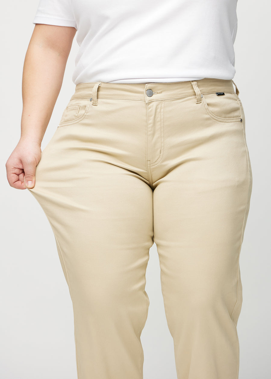 Regular-Jeans für Damen in Beige, Farbe Gazelles. Ein Plus-Size-Model dehnt den Stoff am Oberschenkel, um den Stretch zu zeigen.