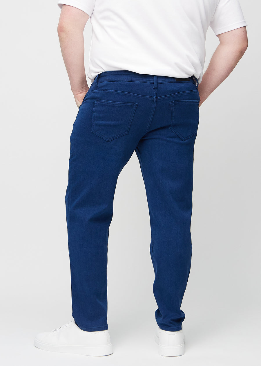 Dunkelblaue regular jeans von hinten an einem Plus-Size-Model gesehen, damit man das gesamte Produkt sehen kann.
