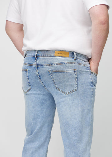 Heller Denim regular jeans von hinten in Nahaufnahme an einem Plus-Size-Model, um Details zu zeigen.