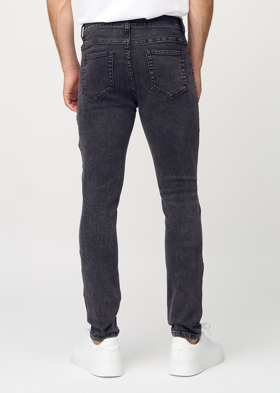 Dunkelgraue Denim-Jeans im Slim Fit, von hinten gesehen, um die gesamte Jeans zu zeigen.