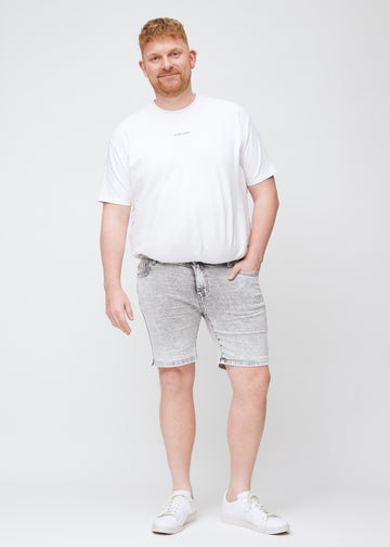 Ganzkörperbild eines Plus-Size-Models in hellgrauen Denim-Middle-slim-Shorts.