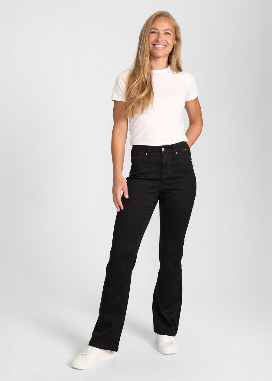 Model går ind i billedet, strækker i jeansene, viser dem frem ved at dreje rundt, og forlader derefter billedet.